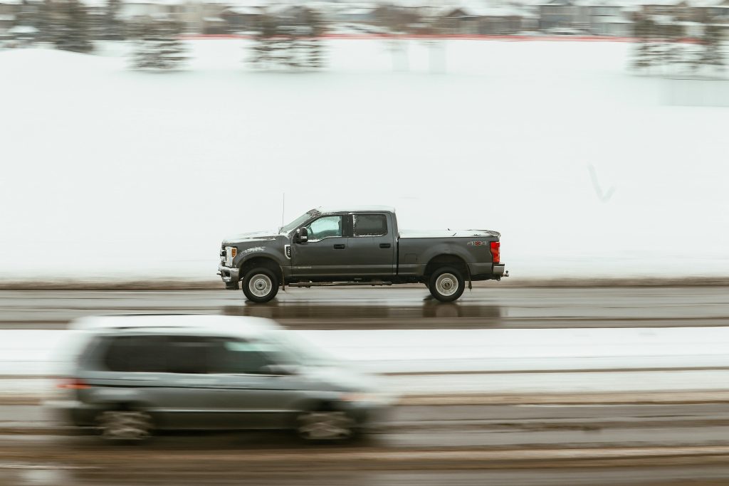 A pickup truck speeds through a snowy highway in Calgary, capturing motion and winter ambiance.